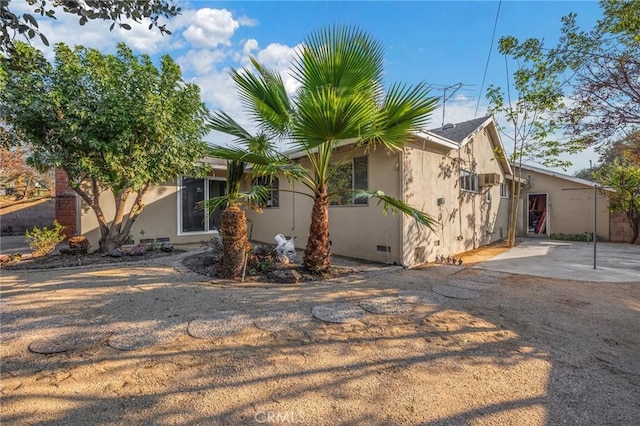 view of property exterior featuring a patio area