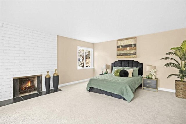 carpeted bedroom with a fireplace