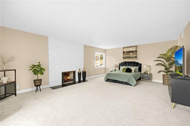 carpeted bedroom featuring a fireplace