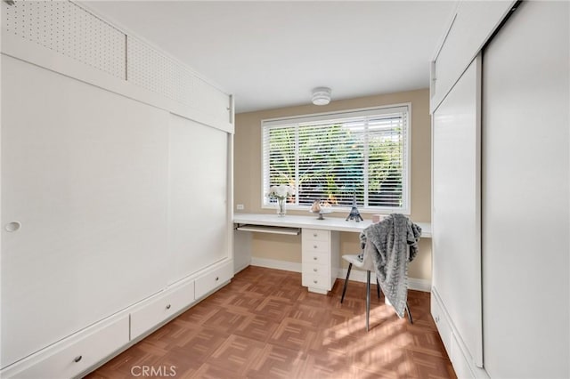 home office featuring built in desk and light parquet flooring