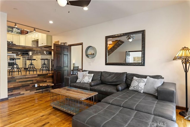 living room with ceiling fan and wood-type flooring