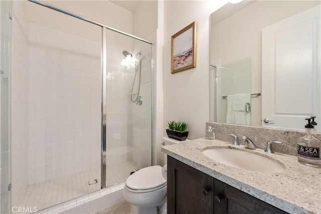 bathroom featuring walk in shower, vanity, and toilet