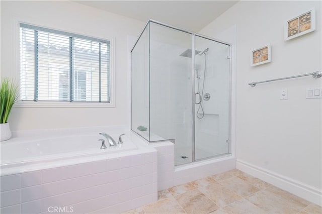 bathroom featuring independent shower and bath