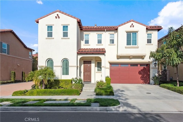 mediterranean / spanish-style house with a garage