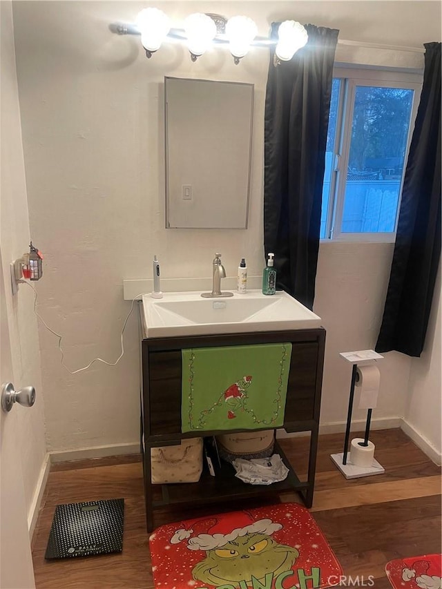 bathroom featuring hardwood / wood-style flooring and vanity