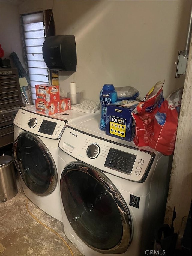 clothes washing area featuring separate washer and dryer