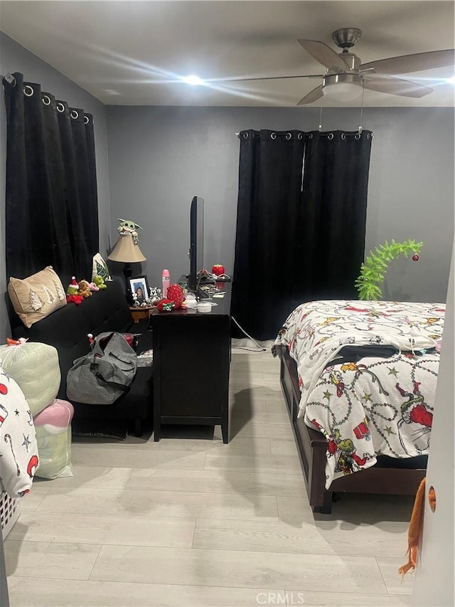 bedroom with ceiling fan and light wood-type flooring