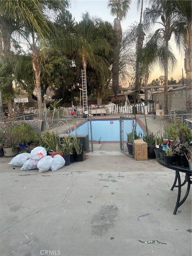 view of pool at dusk