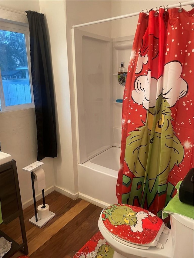 full bathroom featuring toilet, hardwood / wood-style floors, vanity, and shower / bath combo with shower curtain