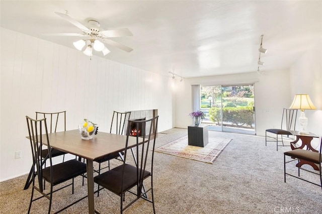 dining room featuring carpet flooring, rail lighting, and ceiling fan