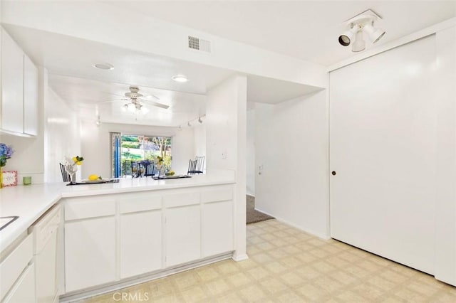 kitchen with dishwasher, ceiling fan, white cabinetry, and kitchen peninsula