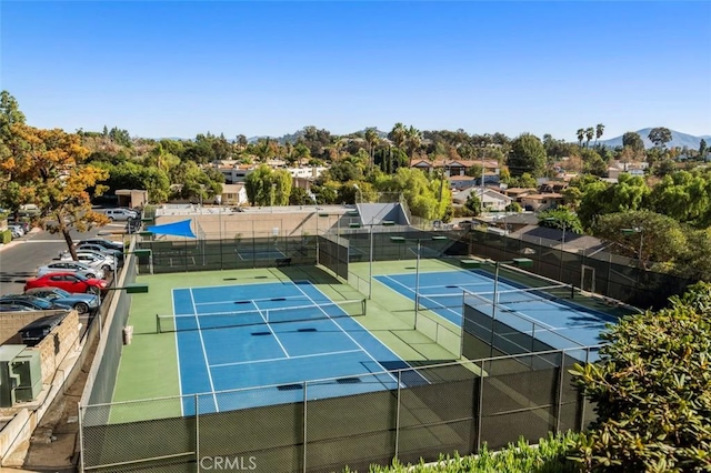 view of tennis court with a mountain view