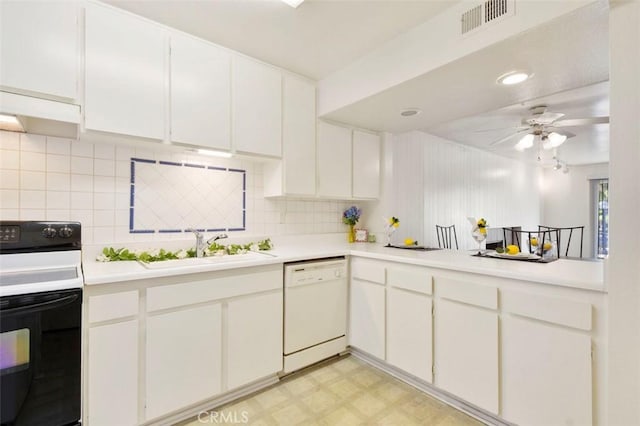 kitchen featuring dishwasher, electric range, white cabinets, and sink