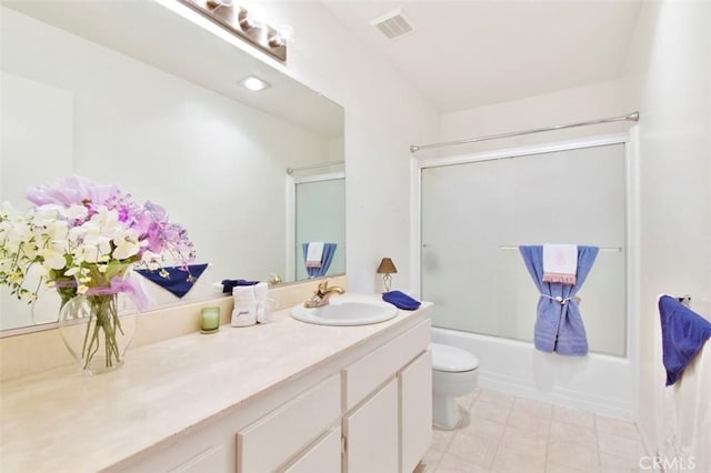 full bathroom with vanity, toilet, and enclosed tub / shower combo