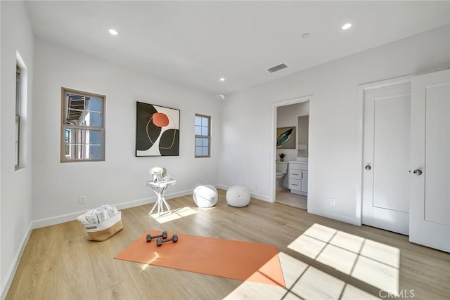 workout area featuring recessed lighting, visible vents, and wood finished floors