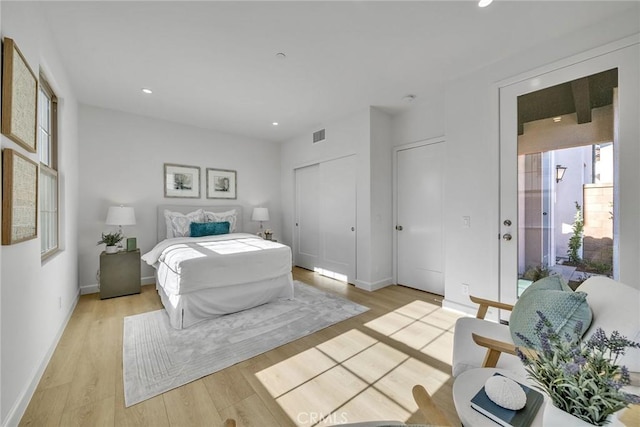 bedroom with baseboards, light wood-style flooring, and recessed lighting