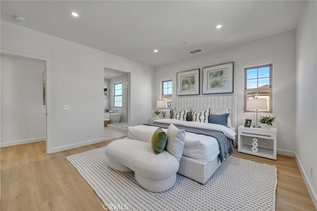 bedroom featuring recessed lighting, visible vents, light wood-style flooring, ensuite bathroom, and baseboards