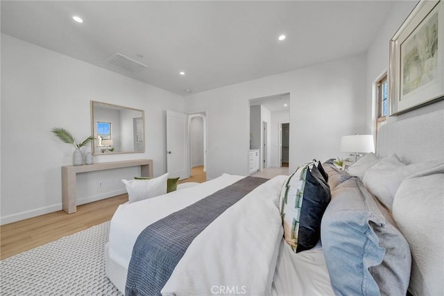 bedroom featuring baseboards, light wood-type flooring, visible vents, and recessed lighting