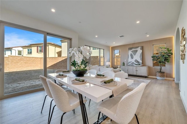 dining room with light wood-style flooring and recessed lighting