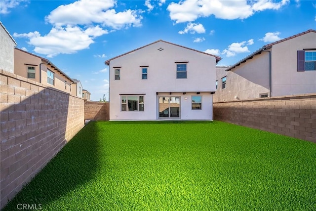 rear view of property with a yard