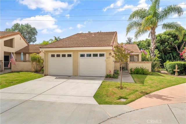 mediterranean / spanish house with a front yard and a garage