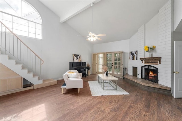 living room featuring ceiling fan, dark hardwood / wood-style flooring, a fireplace, high vaulted ceiling, and beam ceiling