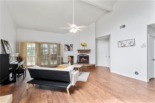 living room with hardwood / wood-style floors, ceiling fan, french doors, high vaulted ceiling, and beamed ceiling