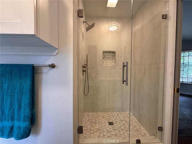 bathroom with a shower with door