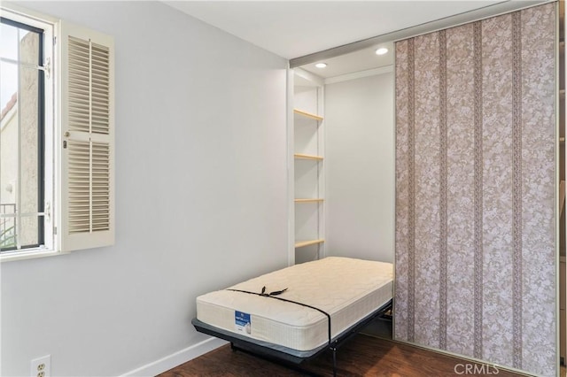 bedroom with dark hardwood / wood-style flooring