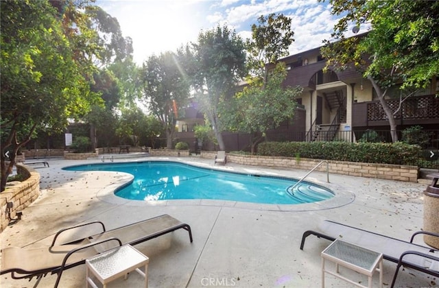 view of swimming pool with a patio area