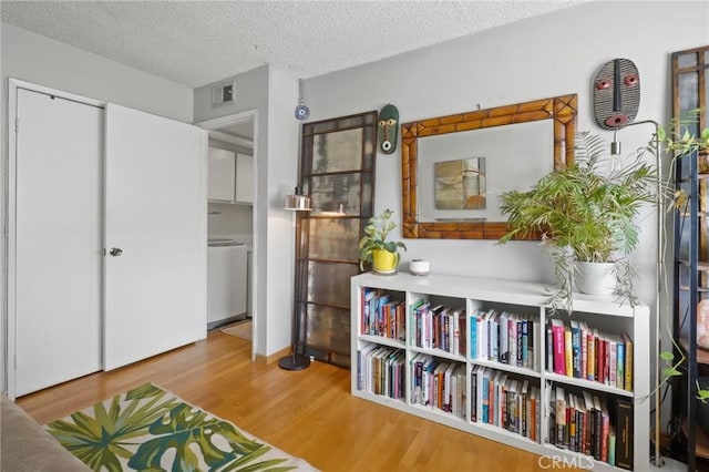 sitting room featuring hardwood / wood-style floors and a textured ceiling