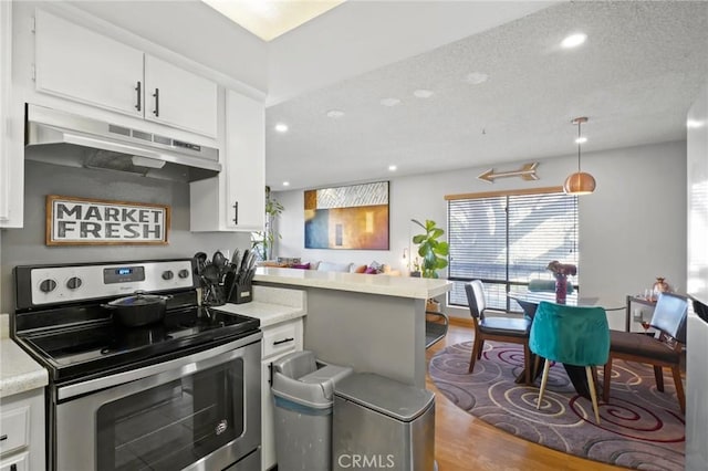 kitchen with pendant lighting, white cabinetry, and stainless steel range with electric cooktop