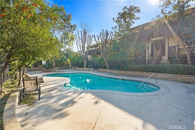 view of swimming pool with a patio area