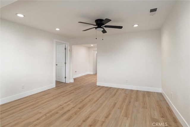 empty room with ceiling fan and light hardwood / wood-style floors