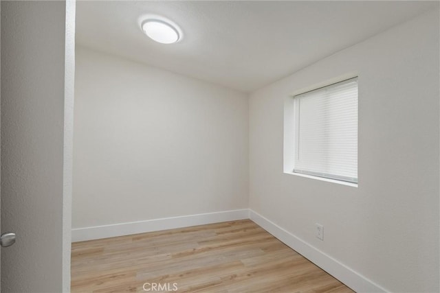 spare room featuring light hardwood / wood-style flooring