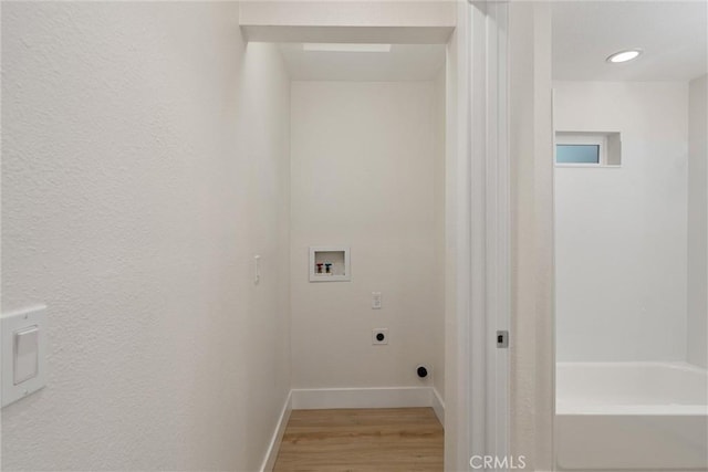 clothes washing area featuring hardwood / wood-style flooring, hookup for a washing machine, and hookup for an electric dryer