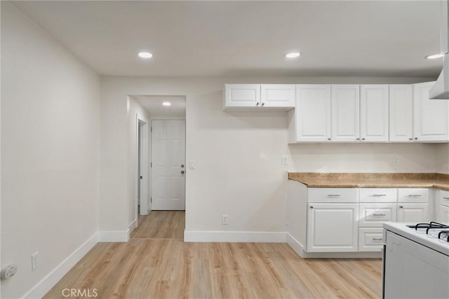 kitchen with light hardwood / wood-style floors and white cabinetry