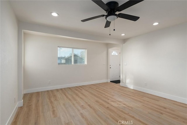 spare room with ceiling fan and light wood-type flooring