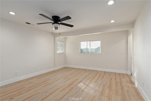 spare room with ceiling fan and light hardwood / wood-style floors