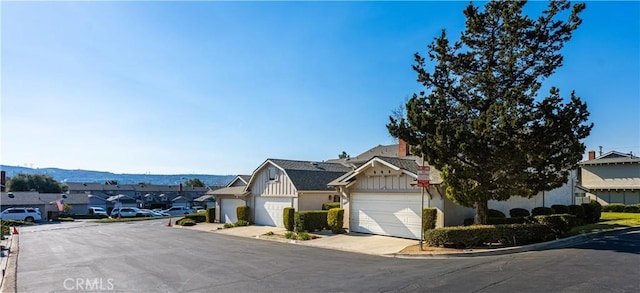 view of front of home featuring a mountain view and a garage