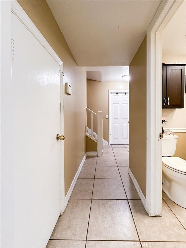 corridor featuring light tile patterned floors