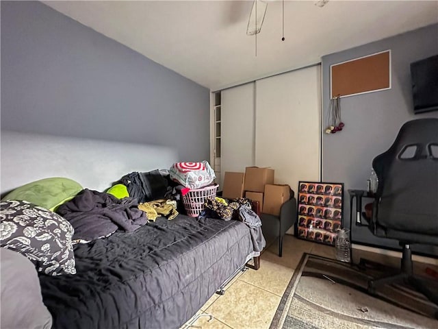 tiled bedroom with a closet