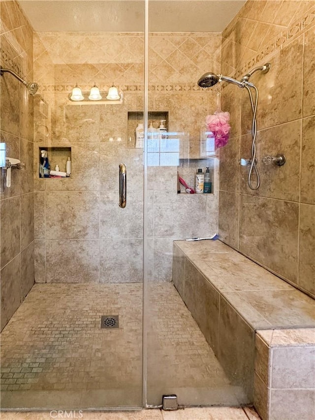 bathroom featuring a shower with door