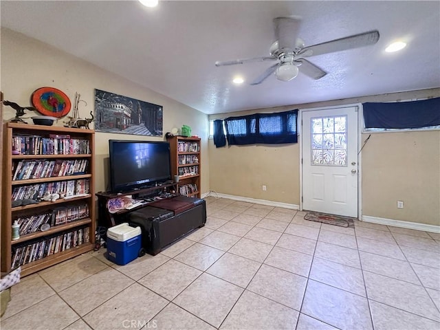 tiled living room with vaulted ceiling, a textured ceiling, and ceiling fan