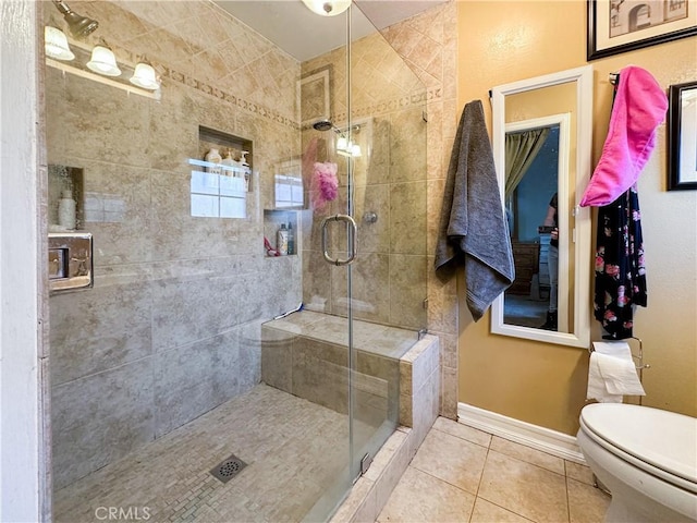 bathroom with tile patterned flooring, an enclosed shower, and toilet