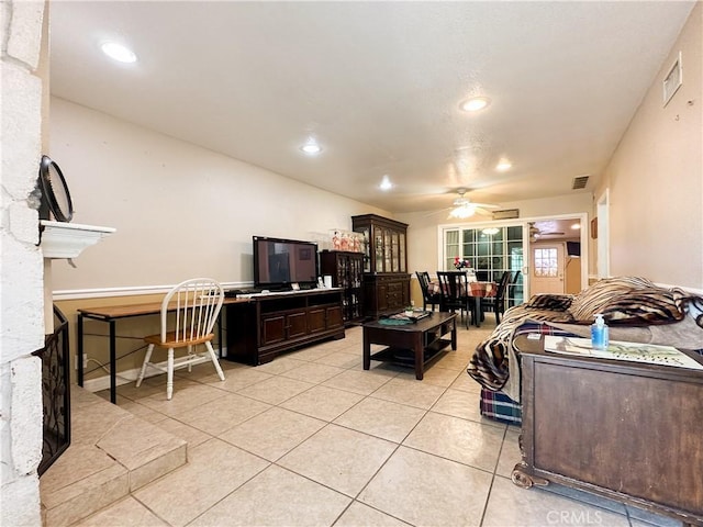 living room featuring light tile patterned floors and ceiling fan