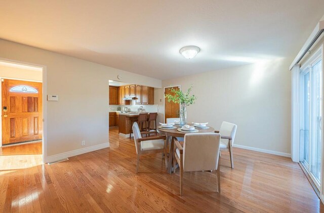 dining area with light wood-type flooring