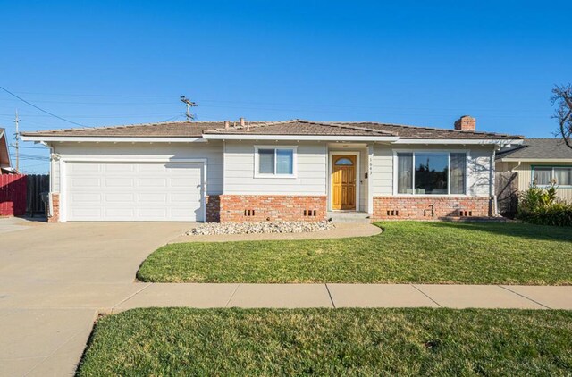 ranch-style home with a front lawn and a garage