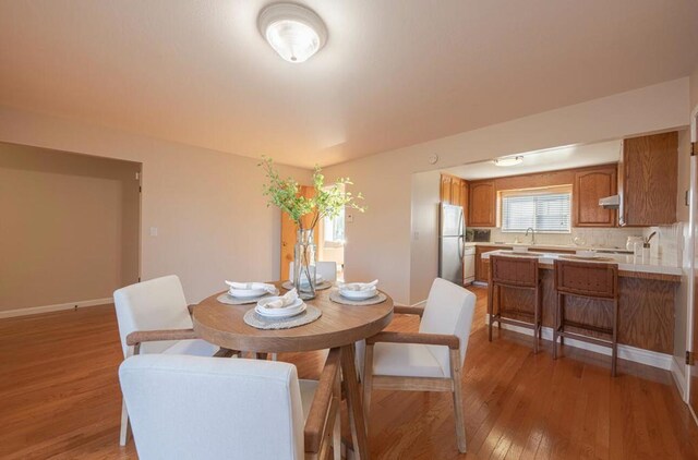 dining room featuring light hardwood / wood-style floors and sink