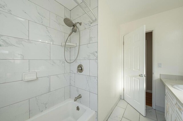 bathroom with tiled shower / bath combo and vanity